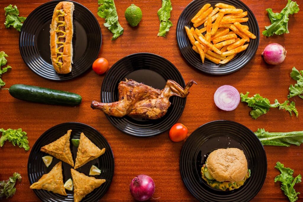 hard to digest foods are these 5 dishes of greasy fast food items: hot dog, fries, burger, fried meat pastry and fried chicken
